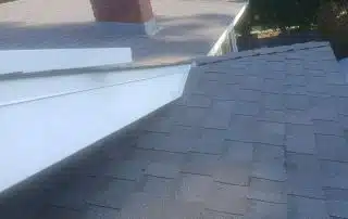 House roof with chimney and trees