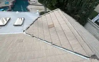 House rooftop overlooking a backyard pool area.