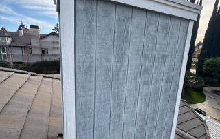 17-Feb 12 2026 03_20pm-Jsis Chimney on shingled roof against cloudy sky.
