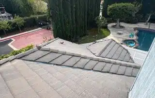 View from rooftop overlooking trees and swimming pool.