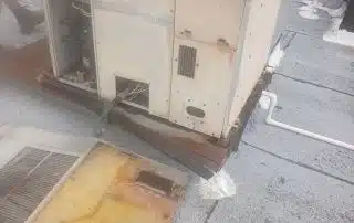 Old rooftop air conditioning unit partially disassembled.