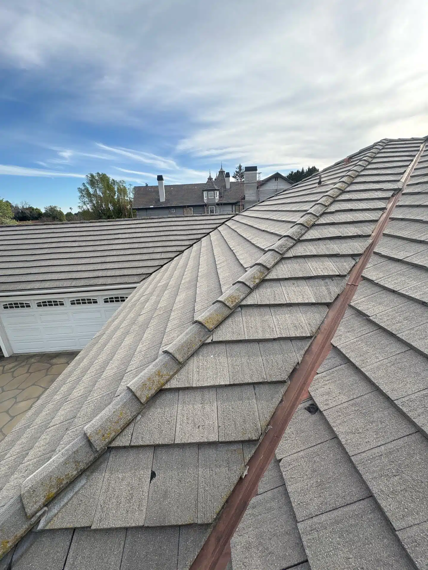 View of residential rooftops under cloudy sky.
