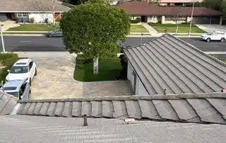 Suburban neighborhood with rooftops and trees visible.