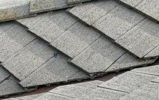 Gray shingle roof with a missing tile