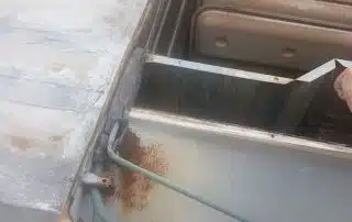 Rusty HVAC duct on rooftop.