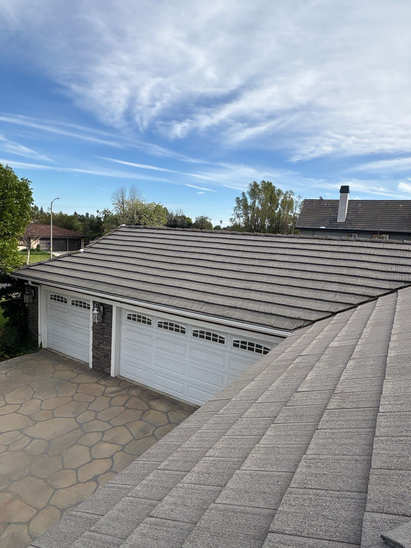 Residential roof with garage and blue sky