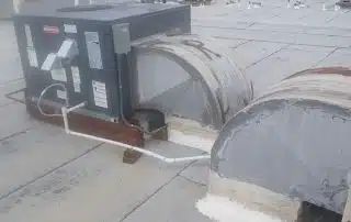 Rooftop HVAC unit installation on commercial building.