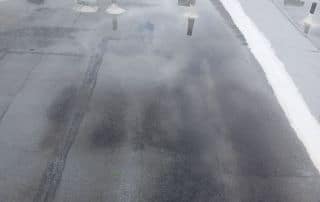 8-Dec 25 2025 01_03pm-hBXr Rooftop with water puddles indicating drainage issues.