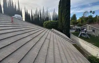 Roof with trees and cloudy sky background