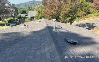 View from residential rooftop overlooking neighborhood and trees.