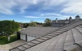 Tiled rooftops under cloudy blue sky
