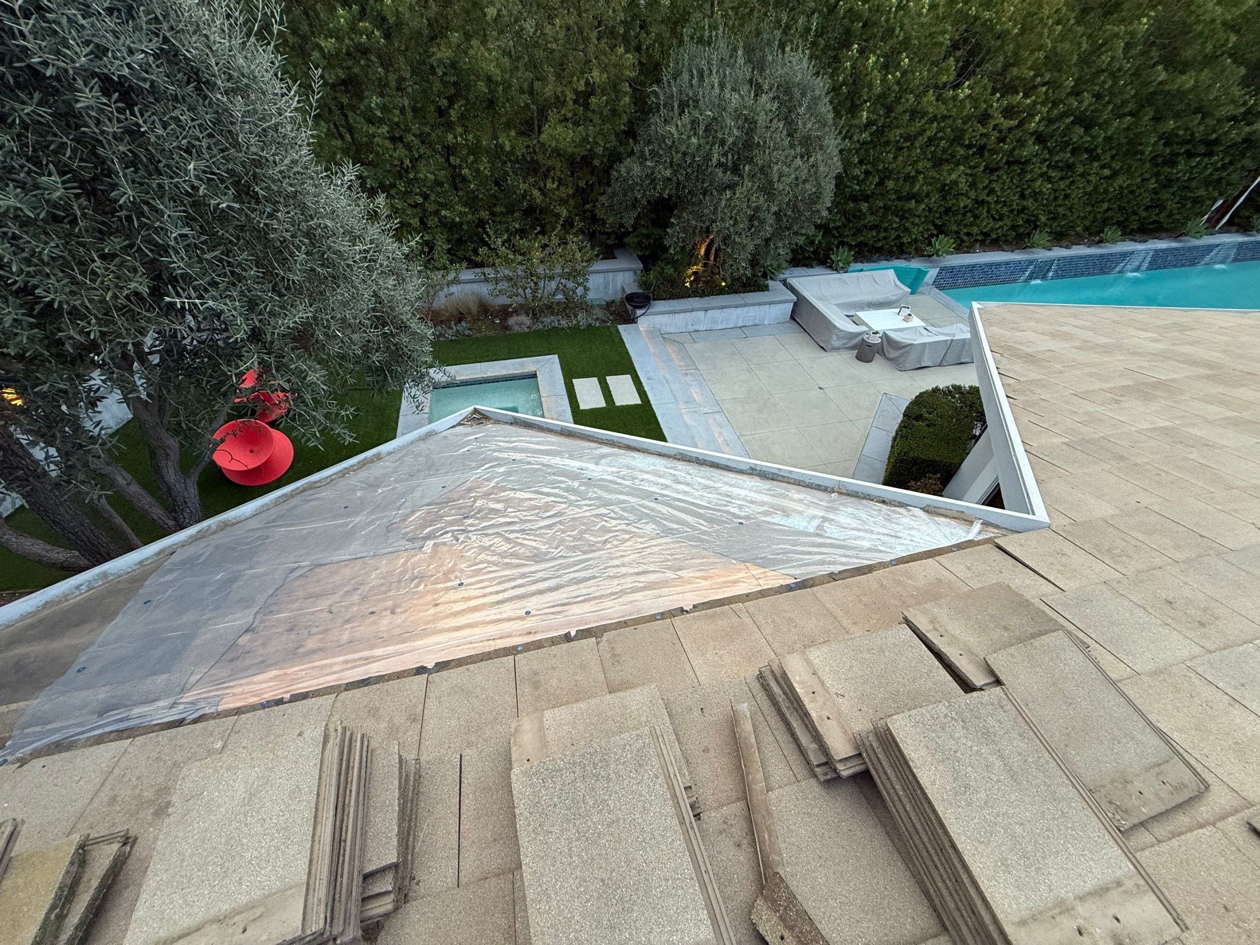 Rooftop renovation overlooking modern backyard with pool