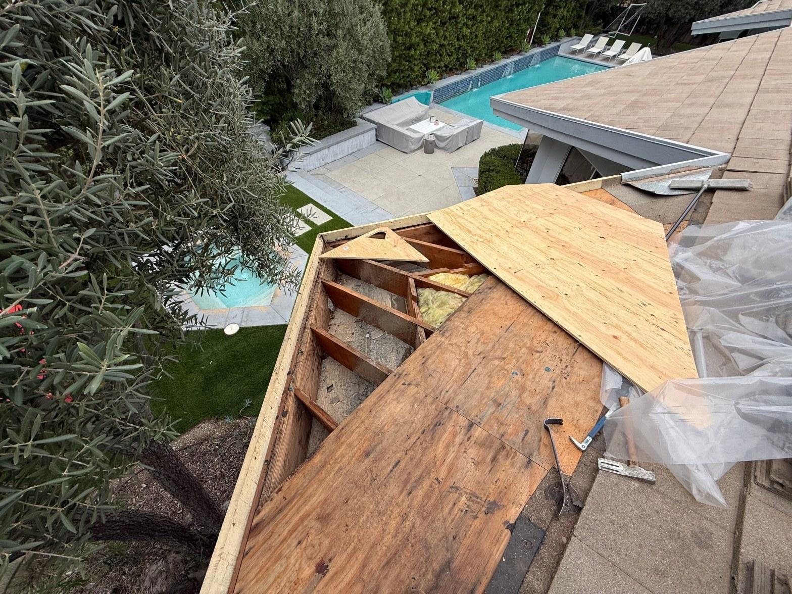 Metal roof flashing around a chimney base on a California residential roof