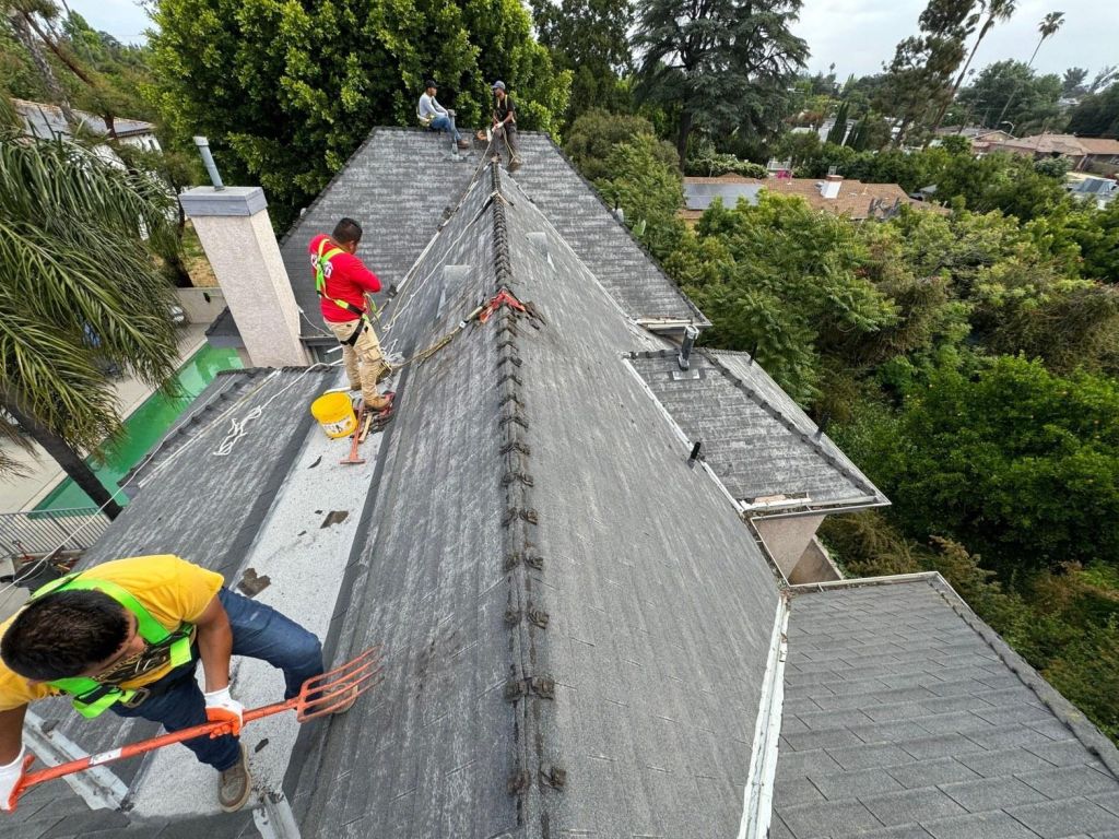 roof-flashing-maintenance-checklist-for-california-homeowner-2384 Roof Repair & Construction roofers working along a ridge on a Los Angeles roof