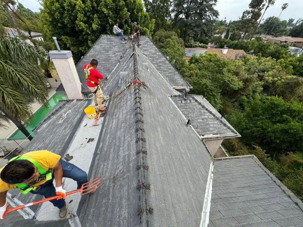 roof-flashing-maintenance-checklist-for-california-homeowner-2384 Roof Repair & Construction roofers working along a ridge on a Los Angeles roof