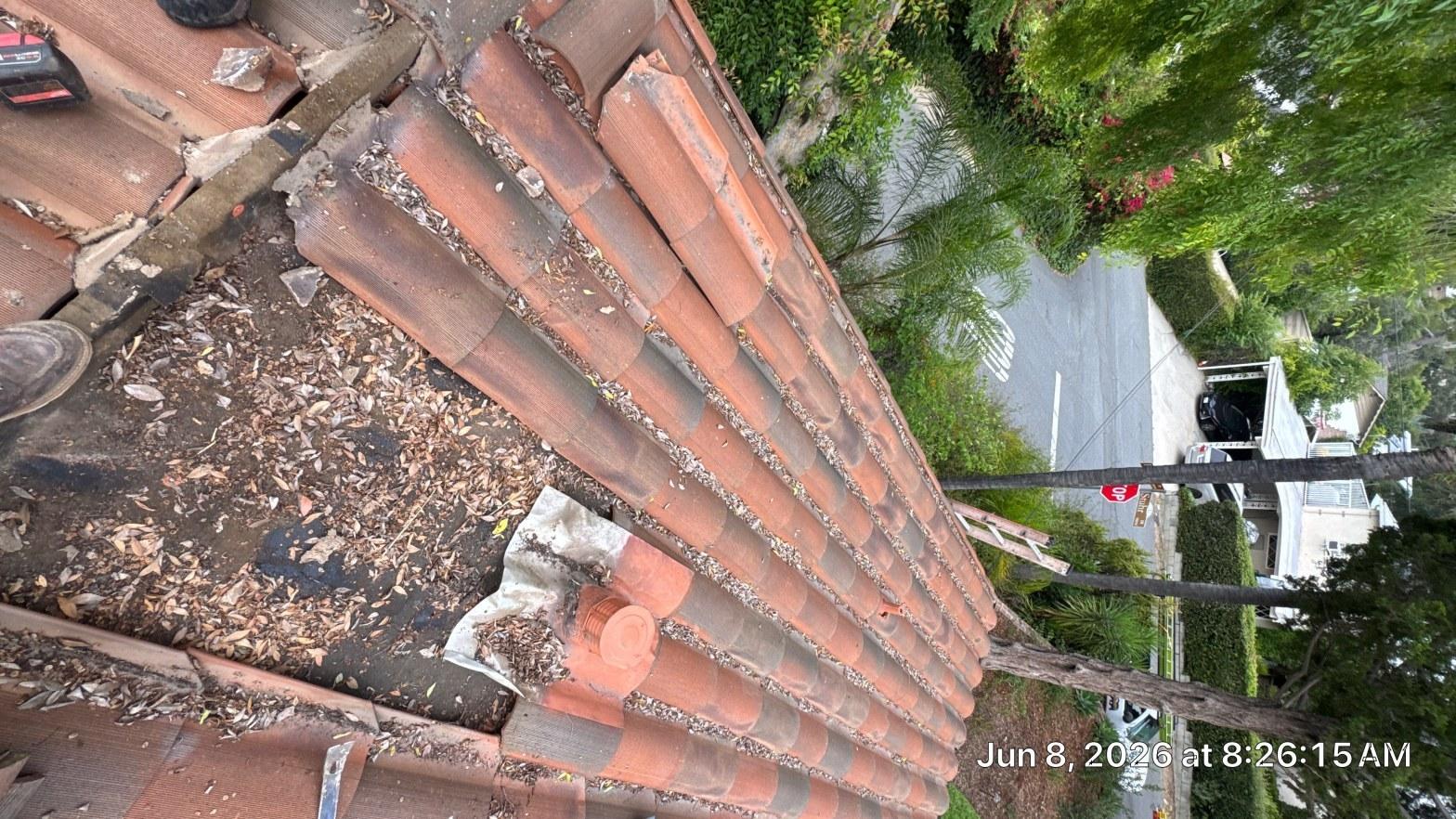 Step flashing and counter flashing at a chimney base on a Southern California residential roof