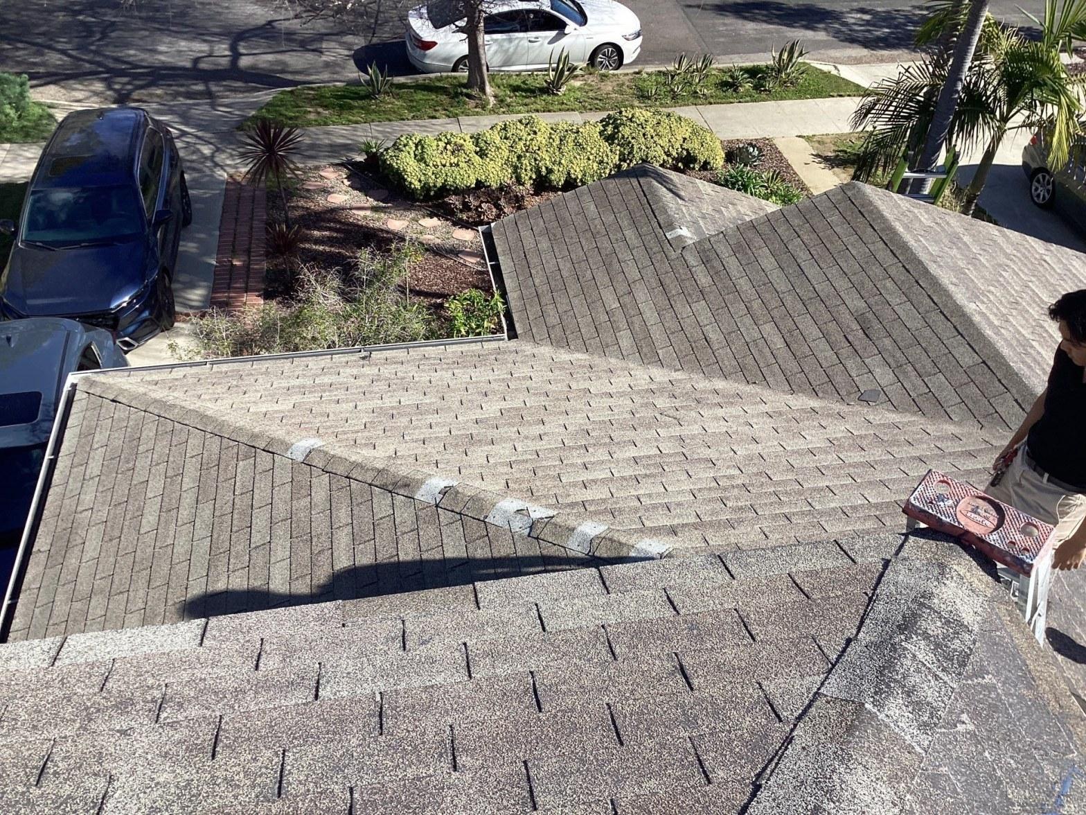 Weathered chimney flashing with rust and cracked sealant on a mid-century home roof in Southern California