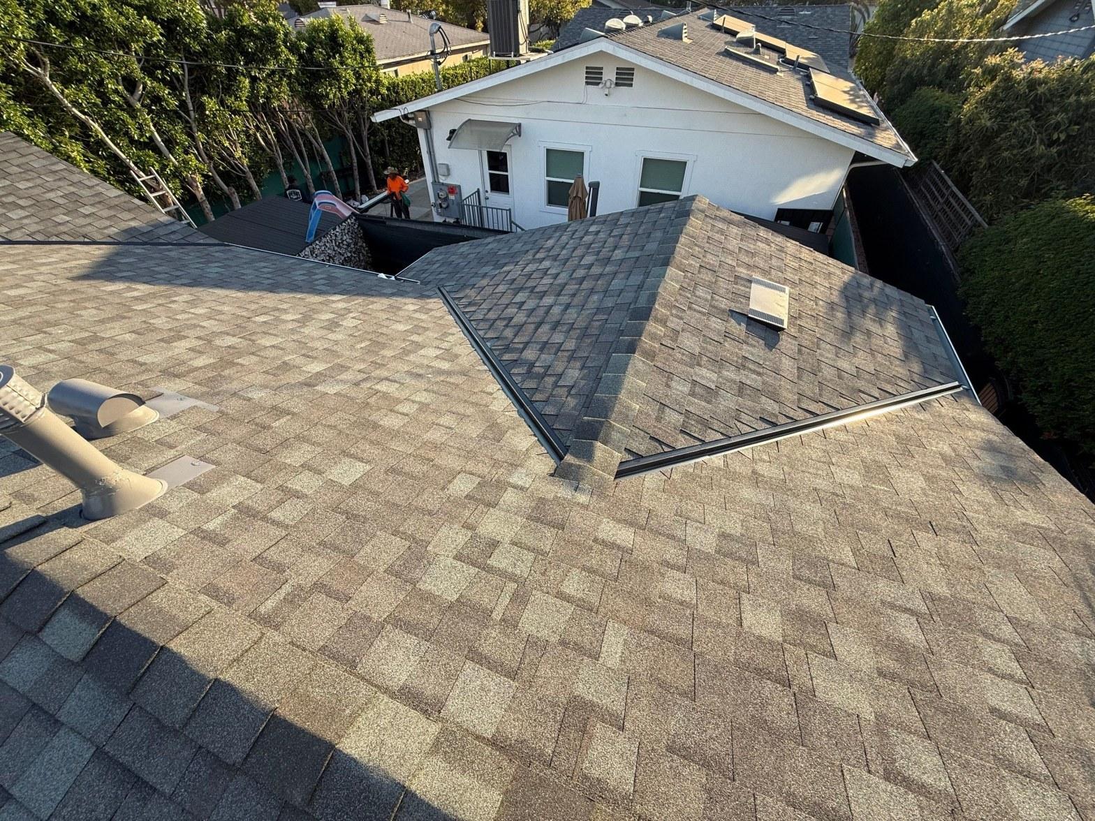 Deteriorating galvanized steel roof flashing at chimney base showing rust and lifted edges on a California home