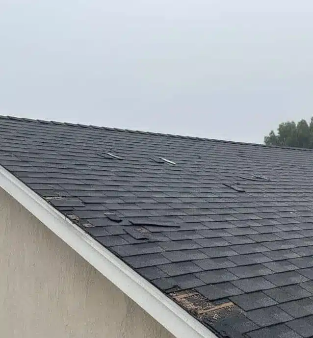 Storm damaged shingle roof needing emergency repair