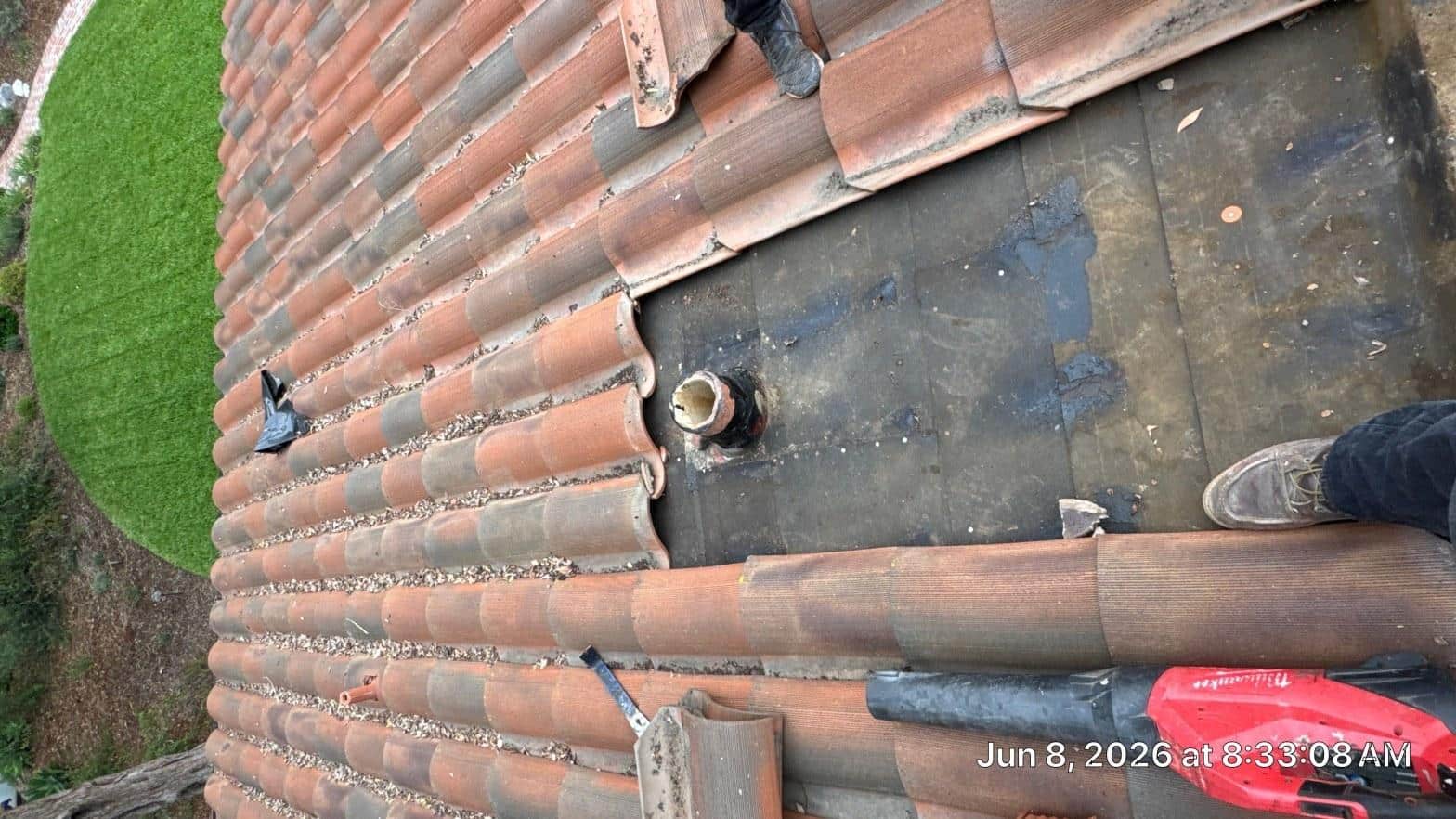 Debris and leaf buildup against valley flashing on a steep hillside home roof in Southern California