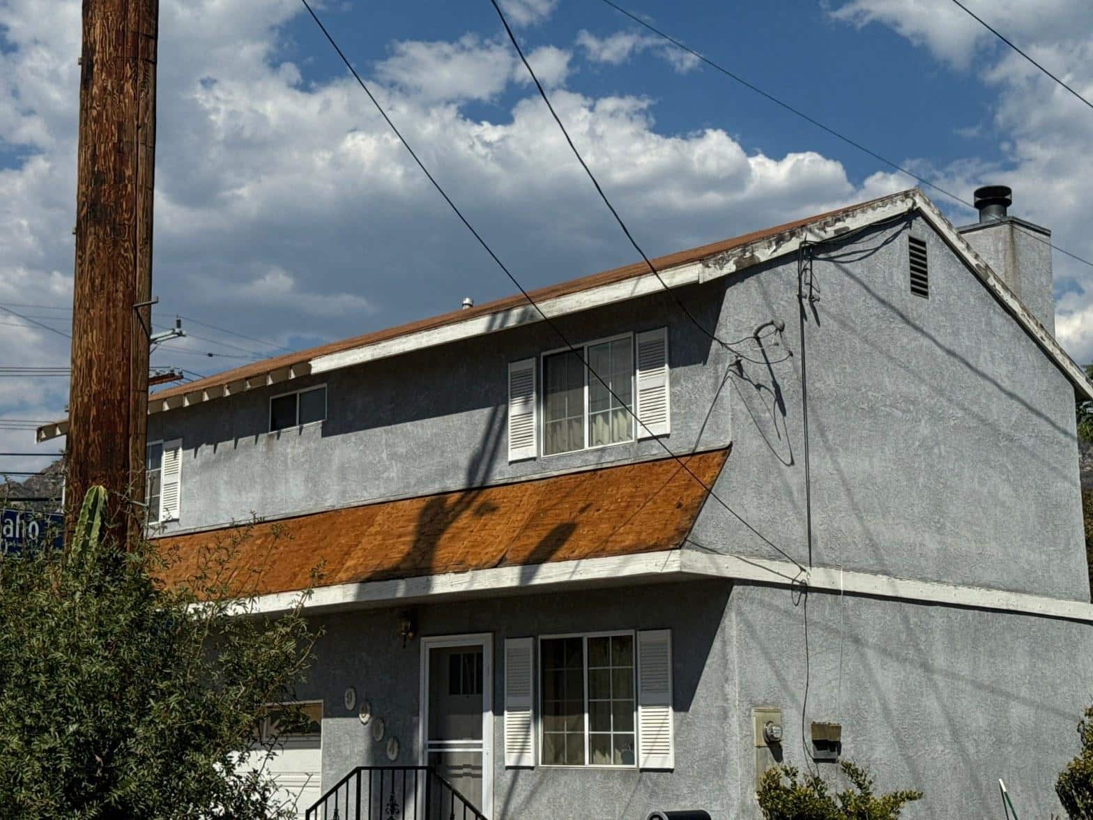 california-roofing-permits-what-homeowners-need-to-know-befo-3949 Roof stripped back to bare decking with replacement roofing material and vents staged along the ridge