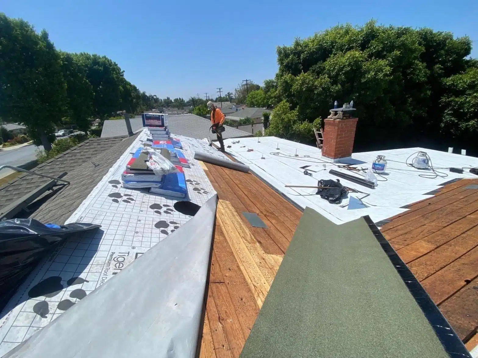 california-roofing-permits-what-homeowners-need-to-know-befo-3953 Roof Repair and Construction Inc. crew installing radiant barrier underlayment across a stripped roof deck